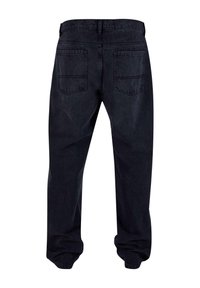Dark denim jeans with a relaxed fit, featuring a waistband, five belt loops, and two back pockets. The fabric has a soft texture.
