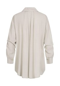 Camicia beige chiaro a maniche lunghe, in misto cotone, con colletto, pieghe sul retro e polsini con bottoni. Tessuto liscio con una vestibilità rilassata.