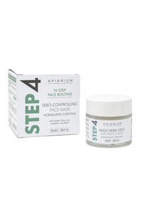 Maschera per il viso controllante il sebo in un barattolo di vetro trasparente con coperchio silver, circondata da una scatola di cartone bianca e verde con testo dettagliato.