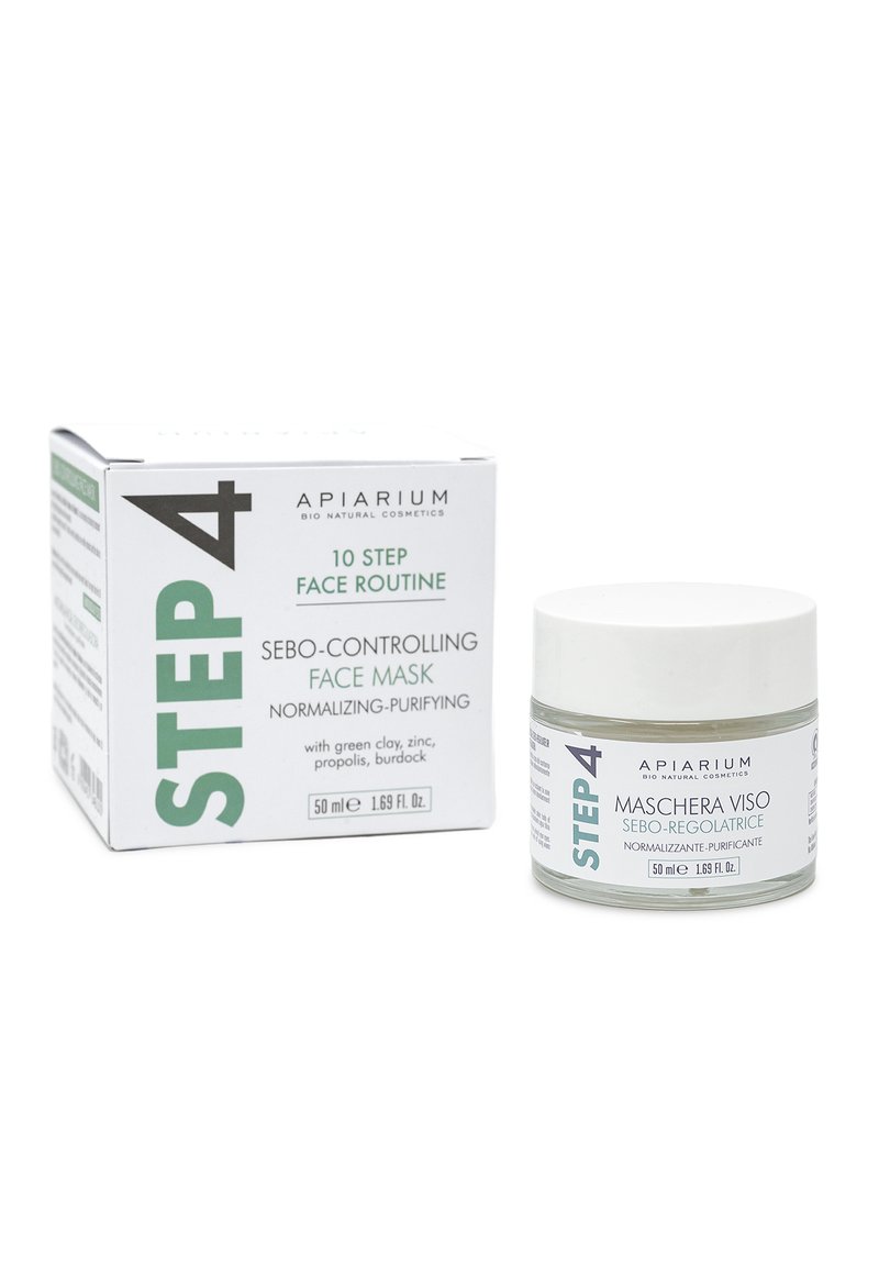 Maschera per il viso controllante il sebo in un barattolo di vetro trasparente con coperchio silver, circondata da una scatola di cartone bianca e verde con testo dettagliato.