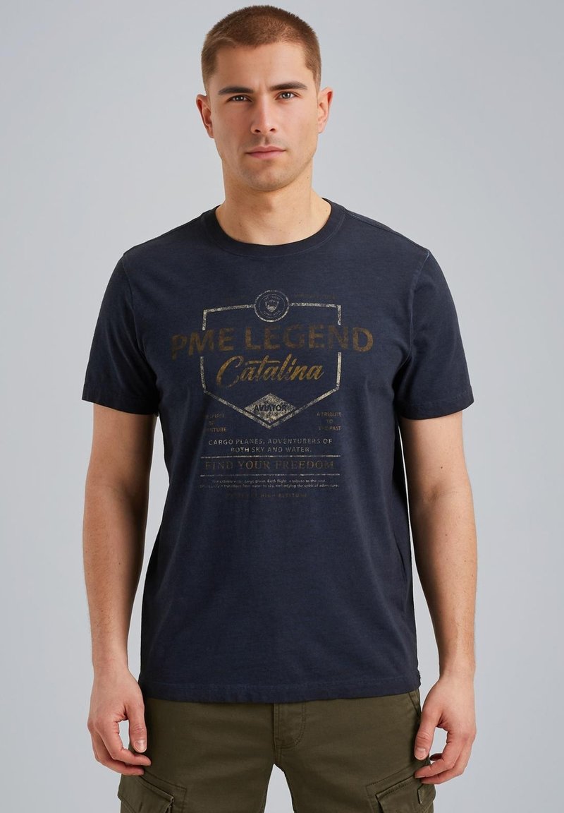 Navy blue cotton t-shirt with a round neck, featuring gold print detailing stating "PME LEGEND Catalina" on the front. Short sleeves.