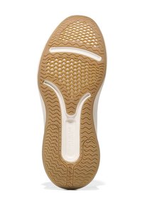 Skosula med en beige gummibas, vågmönster, vit mellansula och texturerad greppyta för bra fäste.