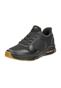 Black athletic shoe with a smooth synthetic upper, rubber sole, and decorative accents. Features a lace-up design and air cushioning.
