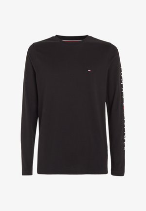 Black long-sleeve shirt made of cotton. Features a small logo on the chest and printed text along the left sleeve in white.