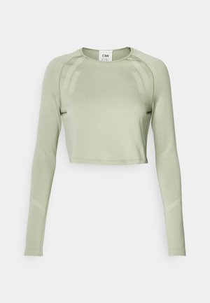 Long-sleeve cropped top in light green fabric with ribbed accents on shoulders and sleeves, featuring a smooth texture and minimalistic design.