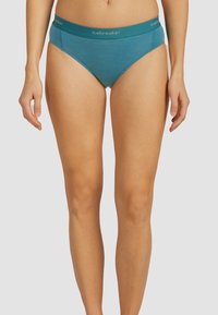 Teal katoenmengsel bikiniondergoed met een brede tailleband, voorzien van het "icebreaker" logo. Soepele textuur met een klassieke snit.