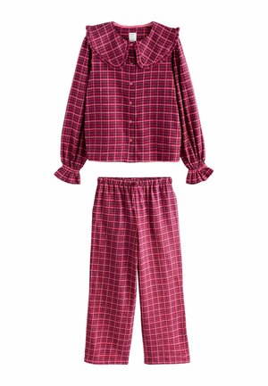 Red and pink plaid pajama set featuring a collared long-sleeve top with button closure and elastic-waisted pants with wide legs.