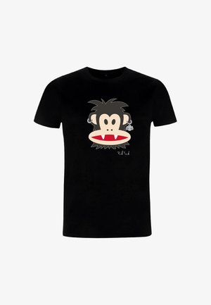 T-shirt en coton noir arborant un dessin de visage de singe cartoon avec des traits exagérés, des crocs et une boucle d'oreille en forme de chauve-souris. Lavable en machine.