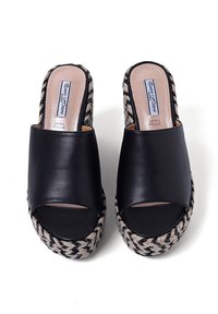 Mule aperti in pelle nera con zeppa in jute a motivo intrecciato. La tomaia ha una superficie liscia e una fascia di larghezza media che attraversa il piede.