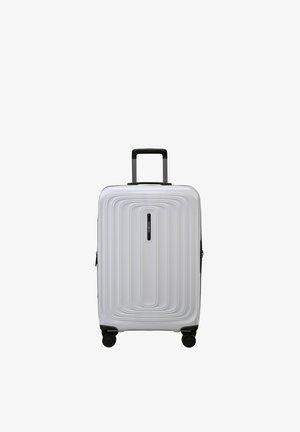 White hard-shell suitcase with four black wheels, a telescopic black handle, and a central vertical design pattern.