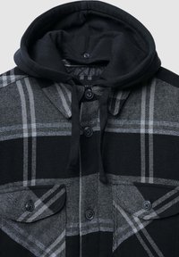 Czarna i szara koszula typu kurtka w kratę z kapturem. Posiada dwie kieszenie na piersiach, czarne guziki oraz miękką teksturowaną tkaninę.
