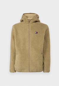 Béžová fleecová bunda na zip s kapucí, s texturovaným povrchem a malým logem na levé straně hrudi. Pohodlná vnitřní podšívka.