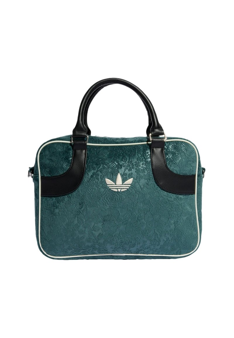 Sac texturé en teal avec des accents et des poignées en cuir noir. Présente un motif floral et un logo Adidas blanc au centre.