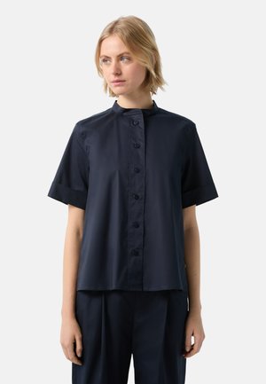 Navy blue short-sleeve shirt with a stand collar, front button closure, and smooth fabric texture. Simple, clean design with no patterns.