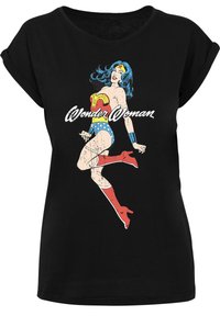 Black T-shirt featuring a Wonder Woman graphic, showcasing vibrant colors, vintage design, short rolled sleeves, and a relaxed fit.