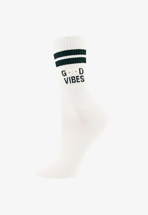 Weißer gerippter Socken mit zwei schwarzen Streifen nahe der Oberseite, schwarzer Text "G D VIBES" mit zwei goldenen Punkten anstelle der "O".