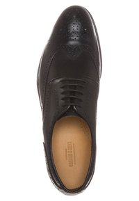 Sort læder dress sko med brogue-detaljer, rund tå og snørelukning. Har en glat overflade og tan-farvet indersål.