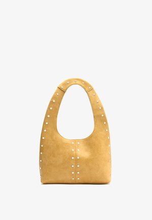Yellow leather handbag with rounded top handle and silver studs along edges and center seam, standing upright on white background.
