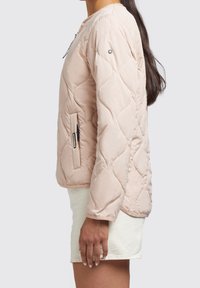 Quilted, light pink jacket with a round neckline, zippered side pocket, and ribbed cuffs. Smooth, padded texture.