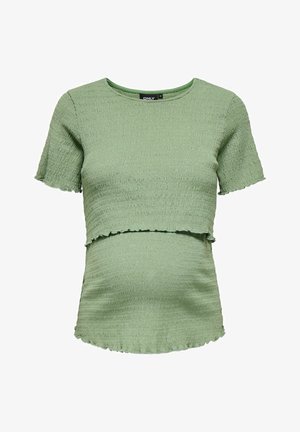 Top de maternidade verde claro, texturizado, com mangas curtas e design cropped. Apresenta um acabamento suave e uma bainha cortada a bruto.