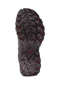 Columbia wandel schoen buitenzool, met een robuuste zwarte rubberen zool met diepe profielen en rode accenten voor grip op diverse terreinen.
