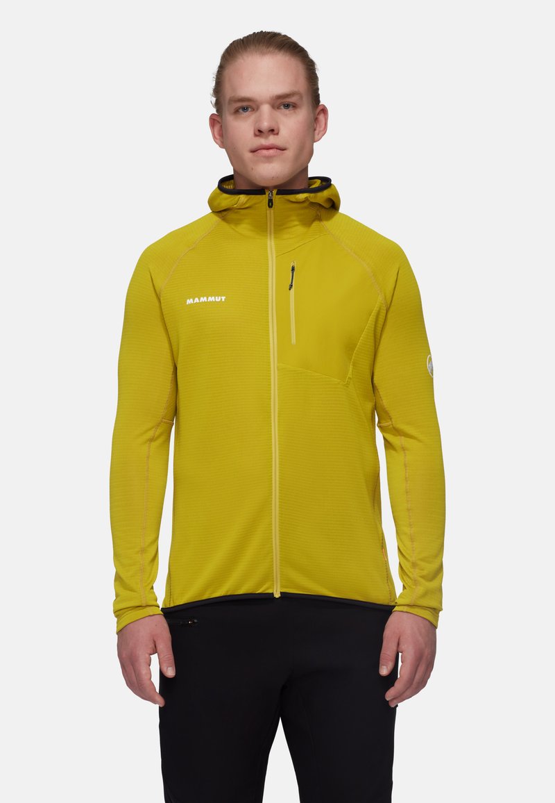 Herrjacka i gult från Mammut med huva som kan dras åt med dragkedja, strukturerad tyg, slim fit och en bröstficka med dragkedja. Har en reflekterande logotypdetalj.