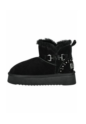 Black ankle boot with a suede upper, fur lining at the collar, decorative metal hardware, studded accents, and a thick rubber sole.