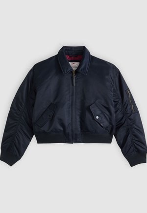 Mörkblå kort bomberjacka med blixtlås fram, två fickor med tryckknappar, blixtlåsficka på ärmen samt ribbstickade muddar och nederkant