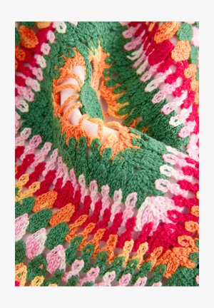 Crocheted textile featuring vibrant colors: green, pink, red, and orange. Intricate patterns with loops and layered textures create depth.