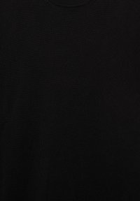 Black fabric with a round neckline, smooth and evenly knitted, likely part of a garment such as a shirt or sweater.