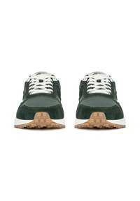 Green suede sneakers with white laces, a padded tongue, and gum rubber outsole. Reflective accents on the side and logo detailing on the tongue.