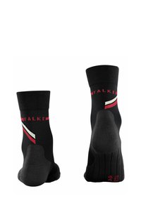 Chaussettes noires avec des bords côtelés, présentant des rayures diagonales rouges et blanches et un talon texturé. La marque est visible sur les côtés.