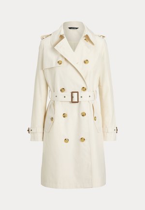 Double-breasted trench coat in cream fabric, featuring gold buttons, matching belt, and shoulder epaulettes. Long sleeves and side pockets.