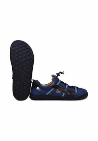 Sandale bleue et noire avec côtés ouverts, lacets ajustables et semelle noire texturée, vue de côté et de dessous sur fond blanc.