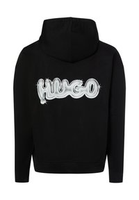 Czarna bluza z kapturem o teksturowanej powierzchni. Na plecach znajduje się duże białe, błyszczące logo „HUGO” z akcentami w kształcie gwiazd. Klasyczny krój z kapturem.