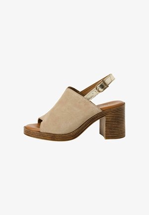 Beige suede heeled sandals with an open toe, slingback strap, and wooden block heel featuring horizontal stripes. Elegant and contemporary design.