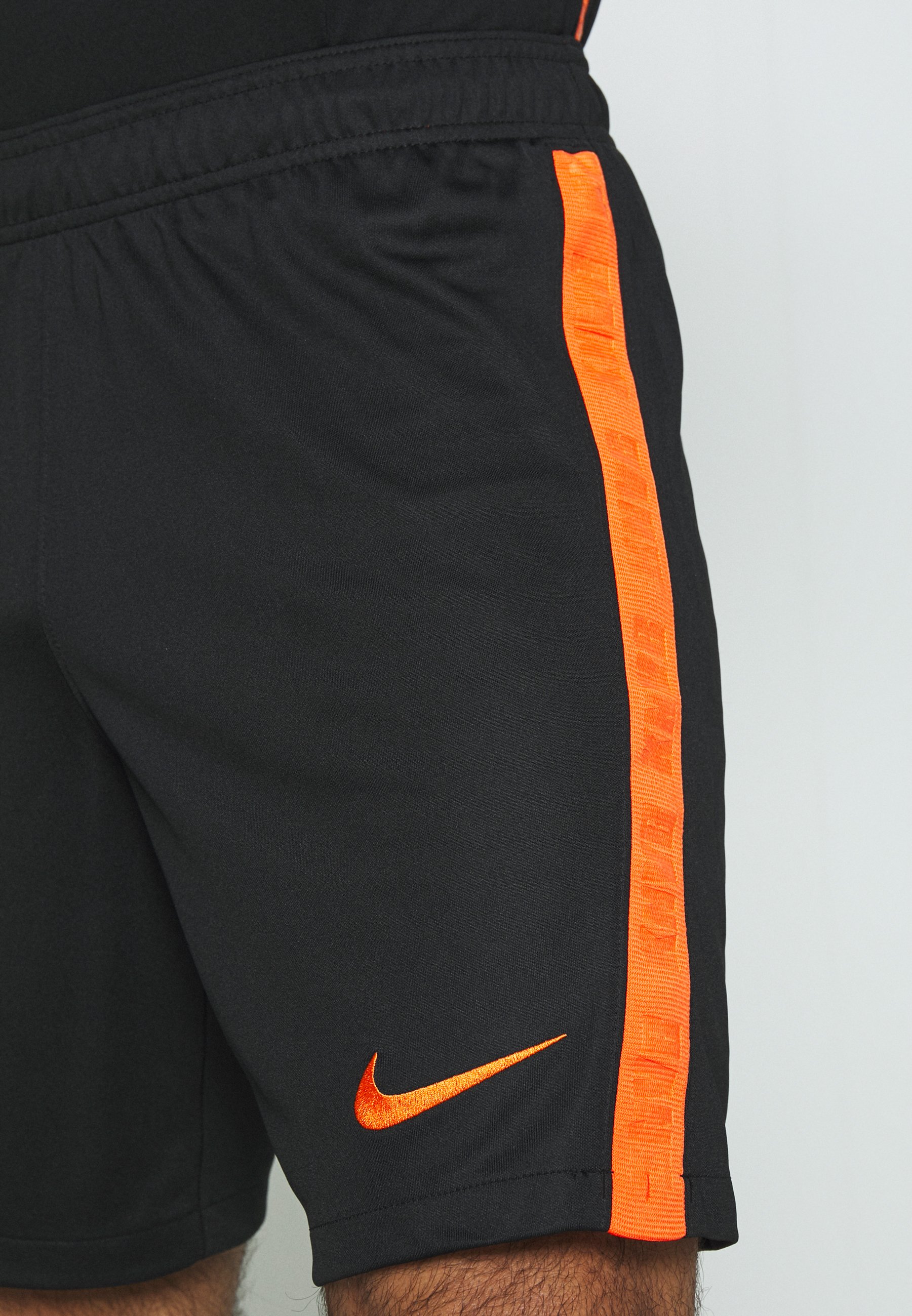 black and orange nike shorts