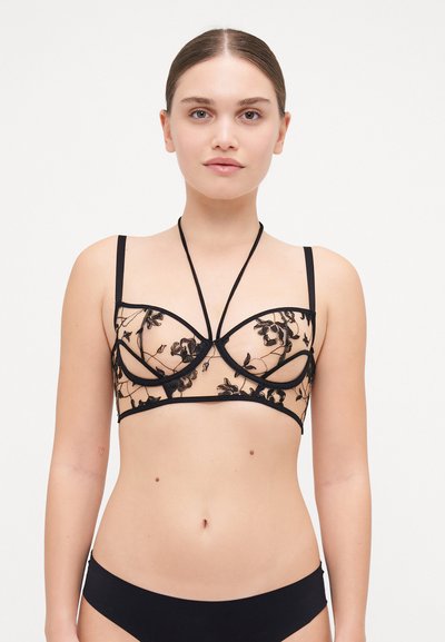 Brassière en dentelle noire avec broderie florale, tissu transparent, soutien-gorge avec armatures et bretelles réglables pour un ajustement personnalisé.