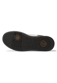 Black rubber outsole with a textured pattern and circular logo detail. Features a white upper and brown accents near the heel.