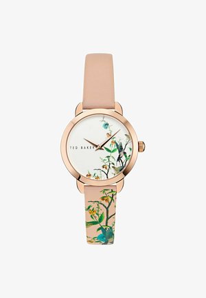 Reloj redondo con caja de tono rosa dorado, cara blanca con gráficos de flores y aves, y una correa de cuero rosa pálido con diseños similares.
