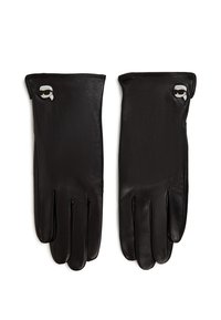 Ett par svarta läderhandskar med små vit- och svartaxelstyled ansiktsnålar nära handleden, liggande platt på vit bakgrund.
