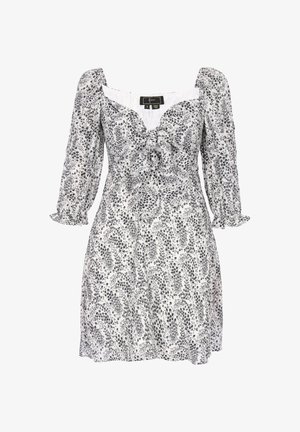 Hvid kjole med sort blomstermønster, puffede lange ærmer, knyttedetalje foran og figursyet talje i et letvægtsstof.