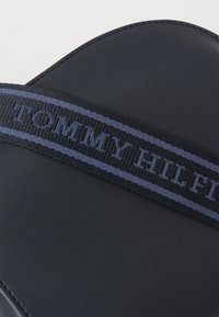 Tommy Hilfiger LOGOTAPE SADDLE BAG - Cross body bag - blue