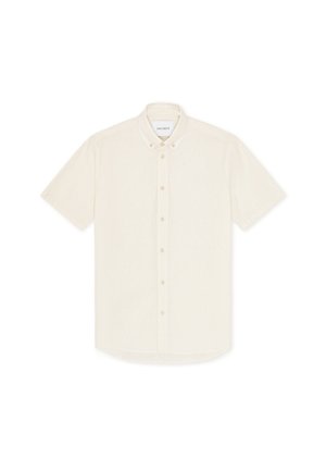 Πουκάμισο με κοντά μανίκια σε εκρού χρώμα, με ελαφρύ ύφασμα, γιακά και μικρά κουμπιά στο εμπρός μέρος.
