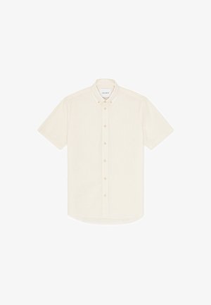 Kortermet skjorte med knappelukking i kremfarge, laget av lett stoff, med krage og små knapper langs fronten.