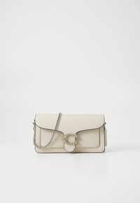 Beige leather shoulder bag with a silver chain strap, featuring a decorative circular clasp embellished with clear stones and rounded edges.