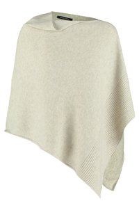 Poncho tricoté couleur crème avec un ourlet asymétrique et des détails côtelés sur un côté, étiquette visible à l'intérieur de l'encolure.