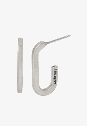 Boucles d'oreilles en argent en forme de crochet avec une texture lisse et polie. Présentent un design à fine boucle, mettant en valeur un style minimaliste et contemporain.