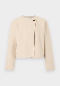 Κρεμ cropped μάλλινο μπουφάν με μακριά μανίκια και ασύμμετρο μπροστινό κούμπωμα που κλείνει με ένα μεγάλο καφέ κουμπί.