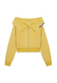 Gilet court jaune avec un col surdimensionné, tissu texturé, fermeture éclair à l'avant, et une étiquette sur le col. Construction lisse et légère.